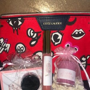 Estée Lauder makeup bag included with lip kit.